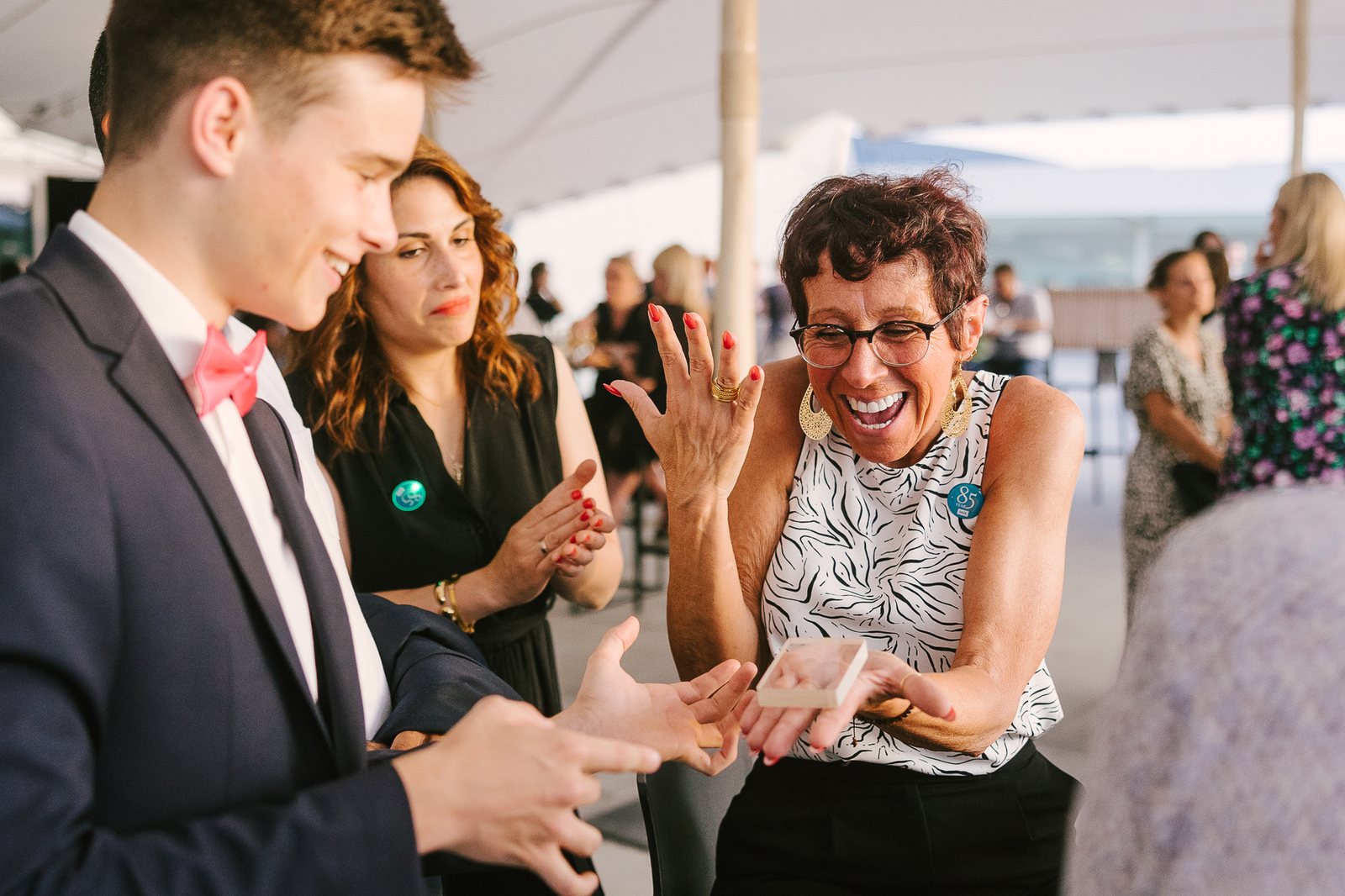 A guest laughing in delight during close-up magic