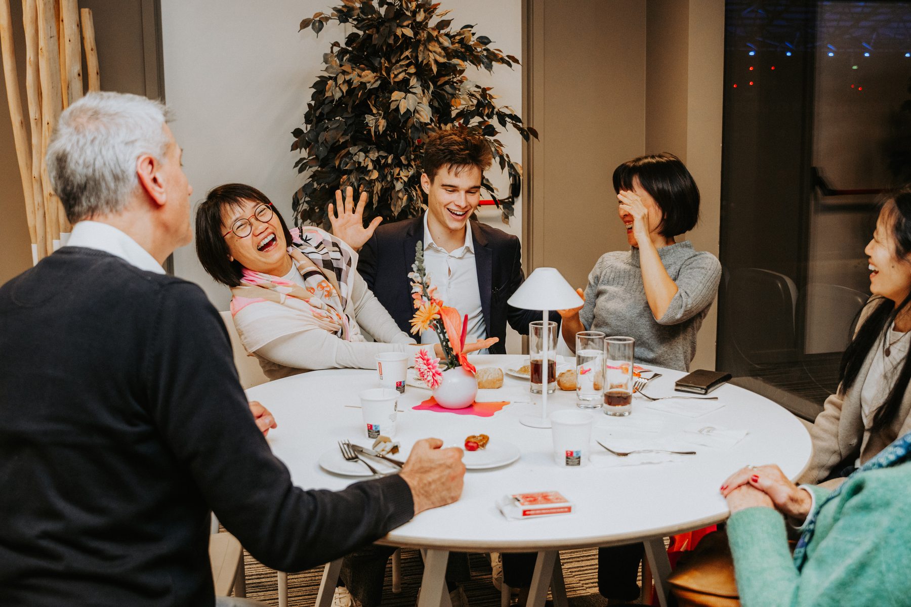 Guests reacting to close-up magic at an intimate table