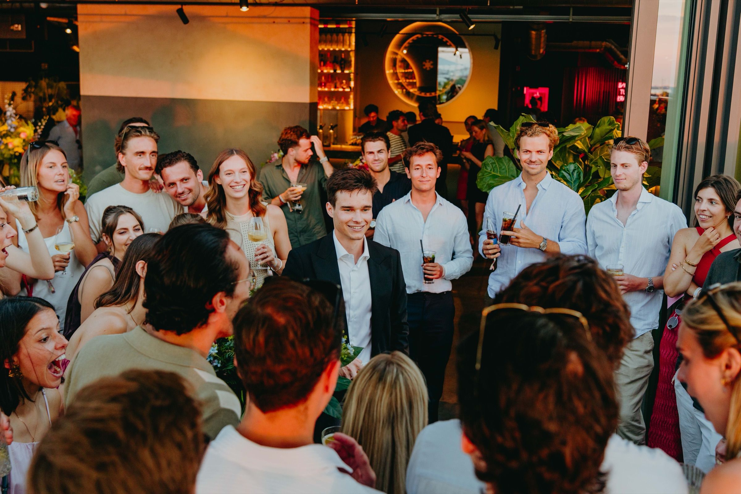 An intimate rooftop gathering during an exclusive close-up magic reveal