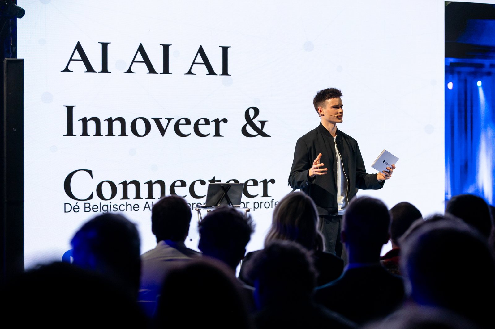 Jonas De Bruyn on stage at a conference