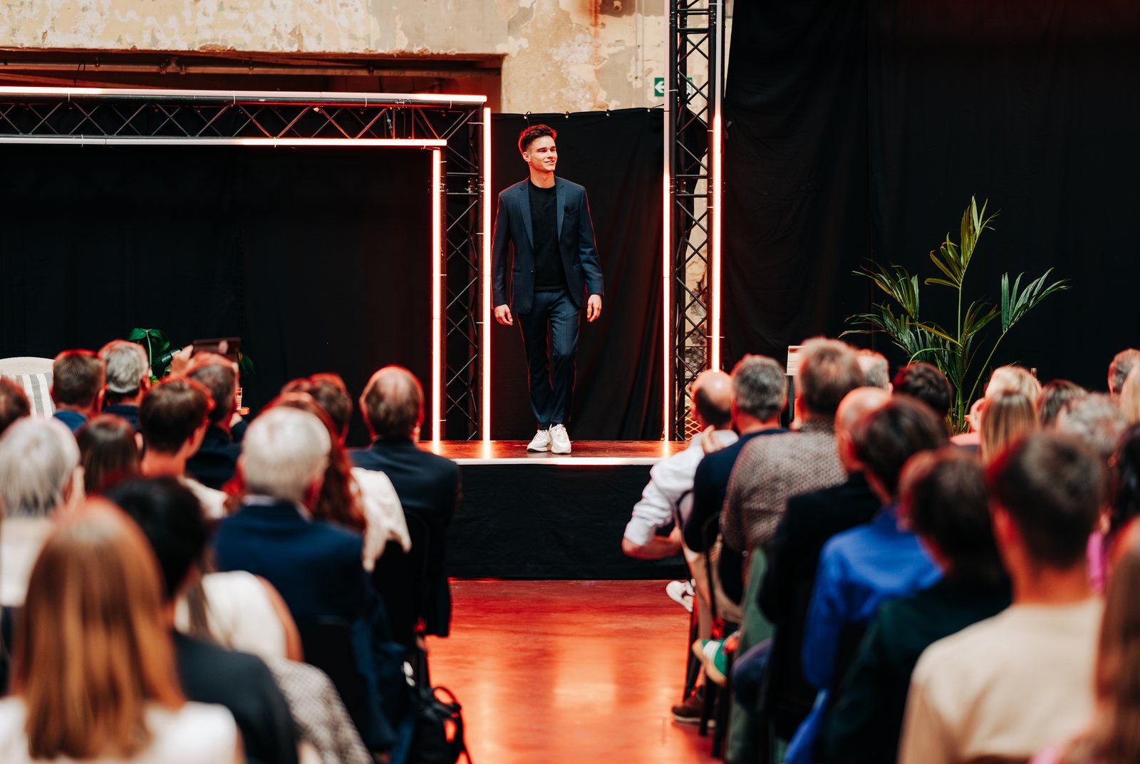 Jonas De Bruyn on stage at a conference