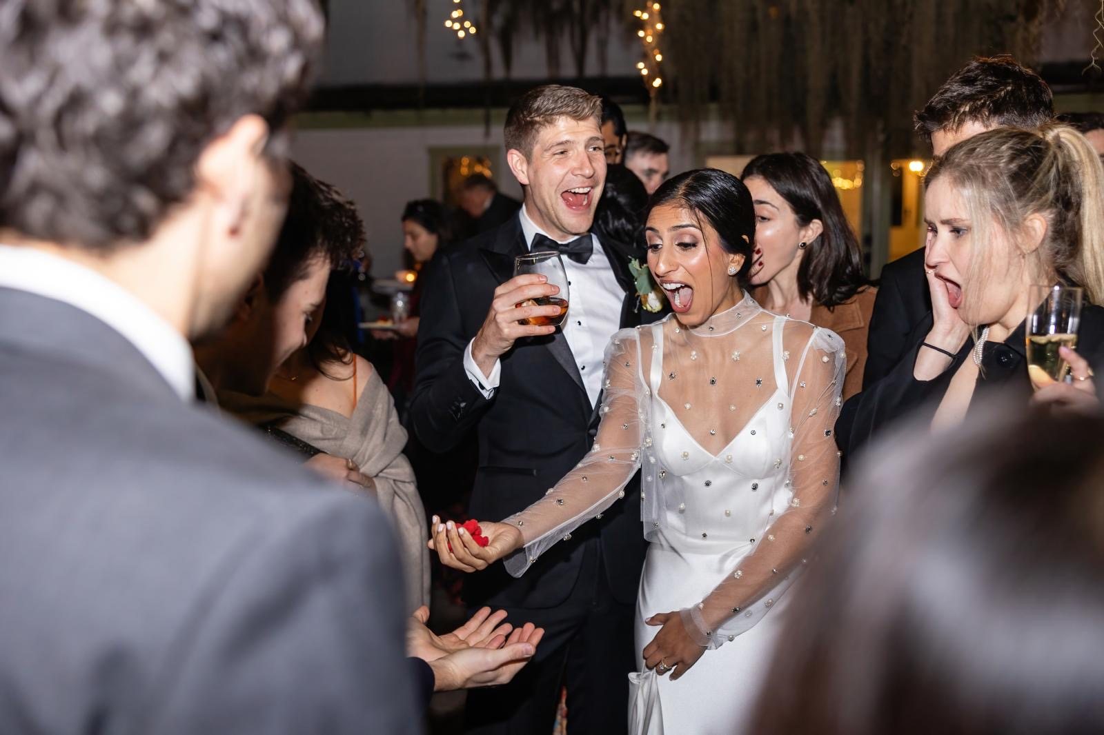 Bride and groom gasping in delighted surprise during a wedding reception performance